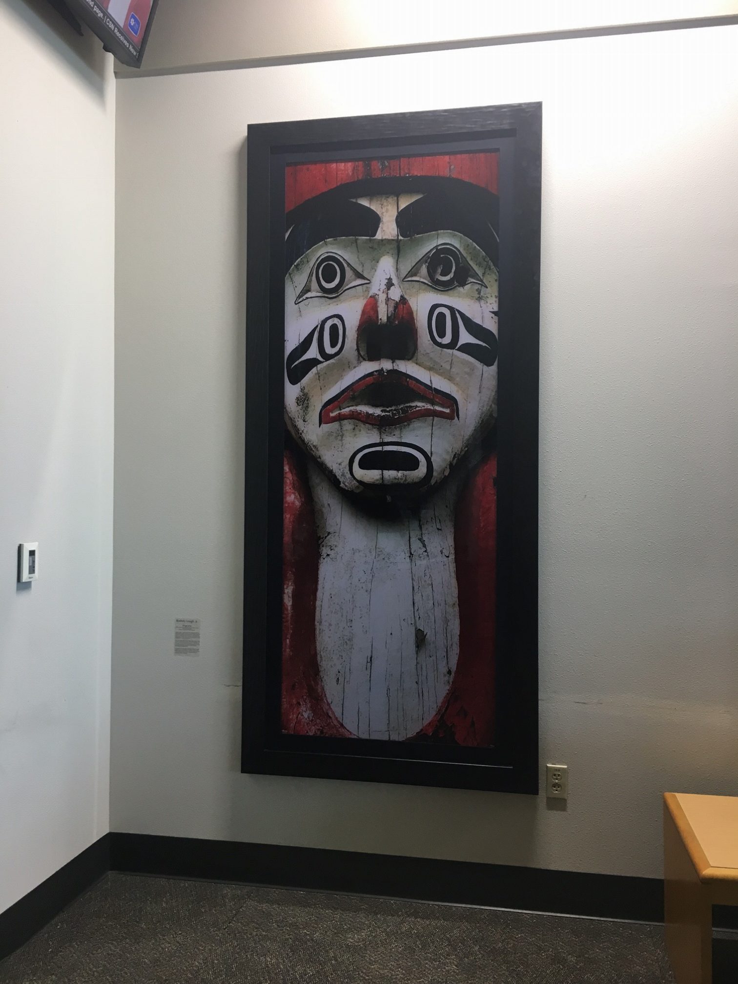 Large painting of face in library