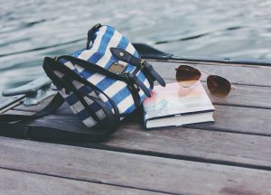 Sunglasses, purse and a book