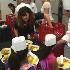 CSN Vice President Patty Charlton helps serve breakfast to children at Lois Craig Elementary School on Thursday.