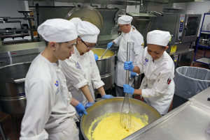 Culinary students often volunteer in the community. Here, a group of students prepares breakfast for at-risk schoolchildren.