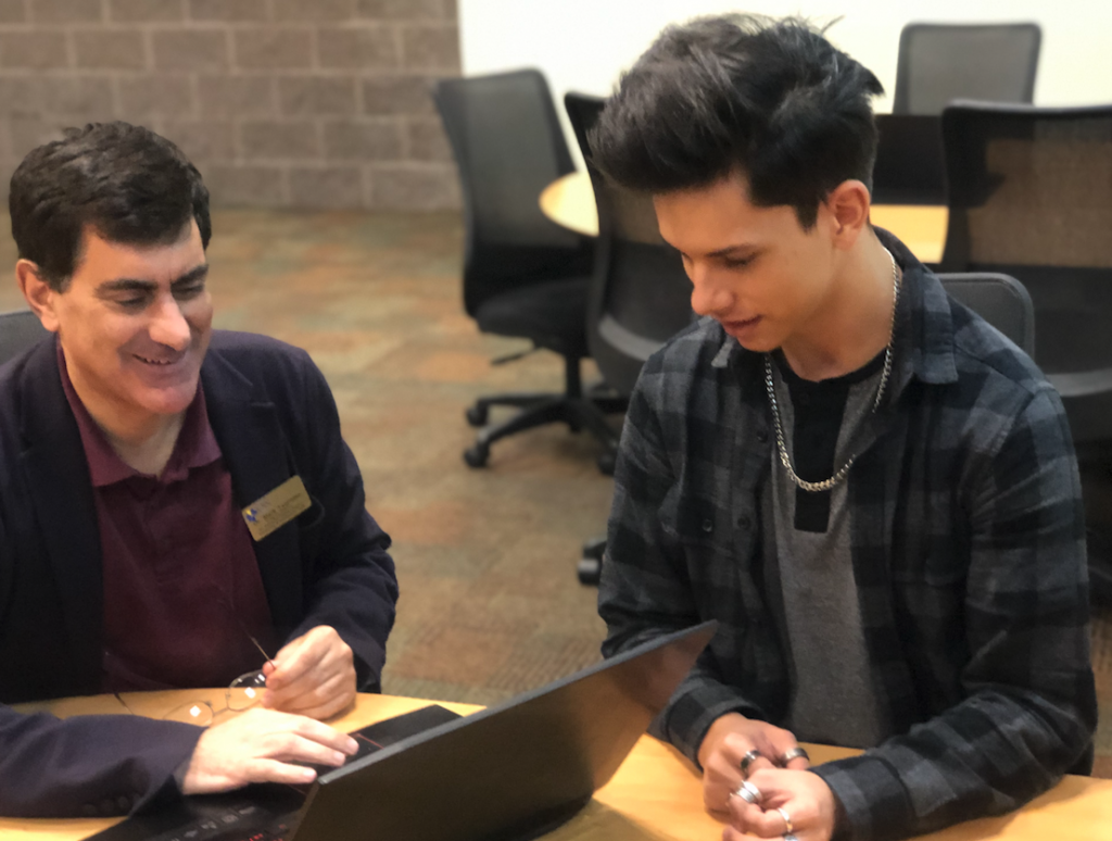 Dr. Mark Taormino and Tyler Guthrie work together in a CSN computer lab.